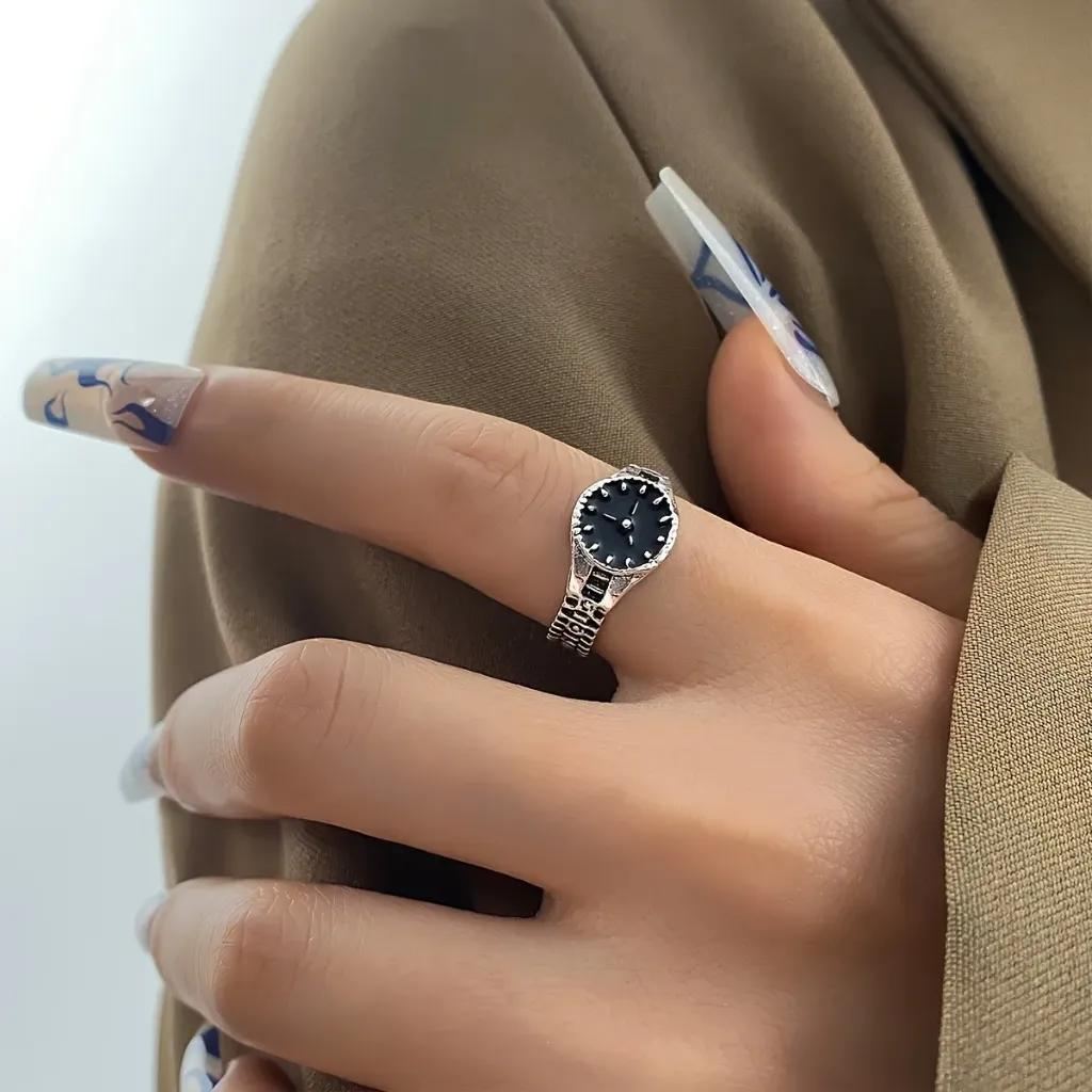 Stainless steel ring shaped as a wristwatch with a black painted dial and a link band
