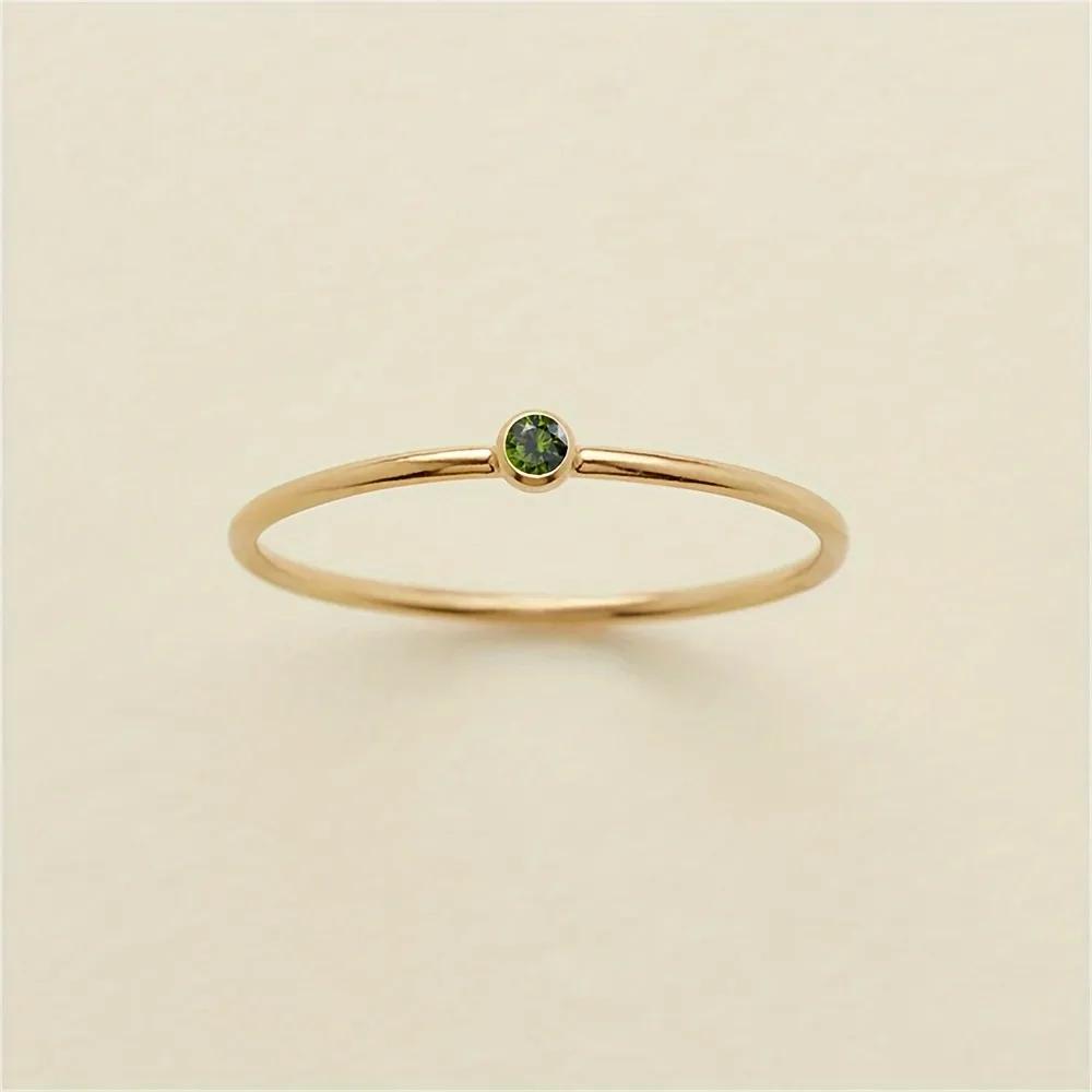 Olive green cubic zirconia sunk flush into a hair-fine gold-plated band