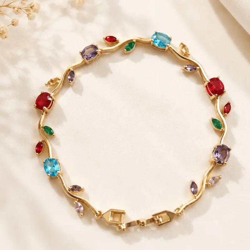 Waved gold-tone bar chain bracelet set with red, blue, green and violet cubic zirconia