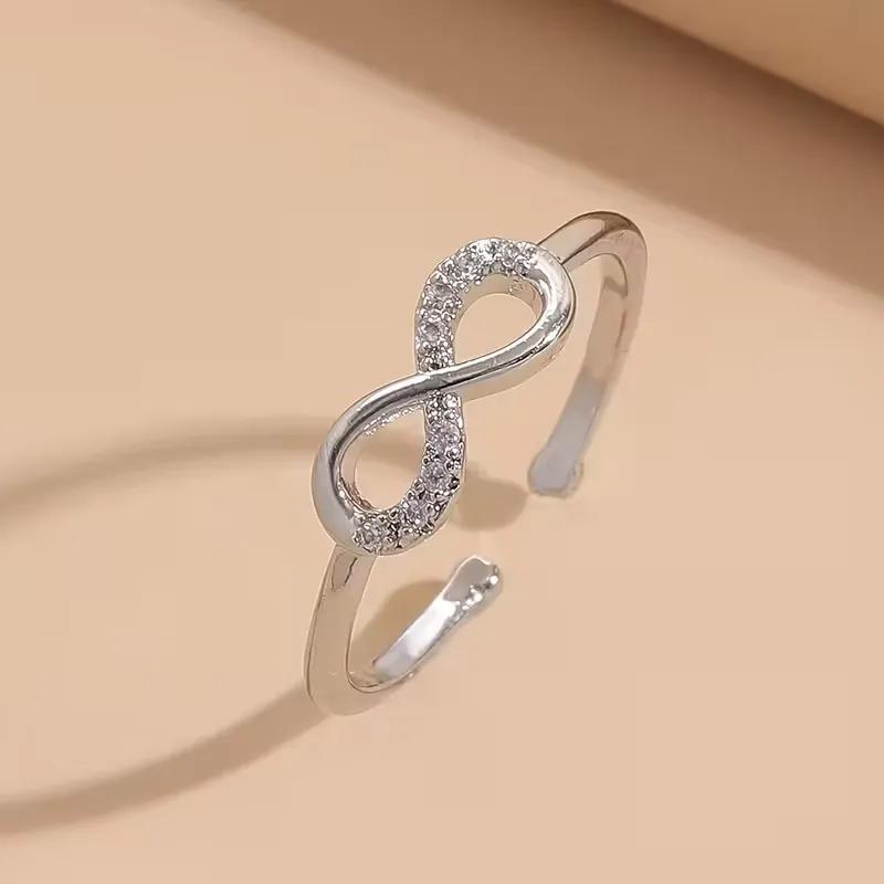 Silver-tone infinity ring with clear stone detailing along an adjustable band