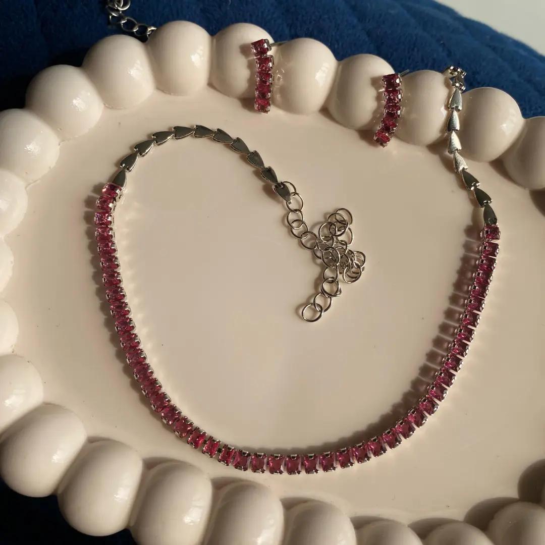 Silver-plated tennis necklace and drop earrings set with a continuous row of pink stones