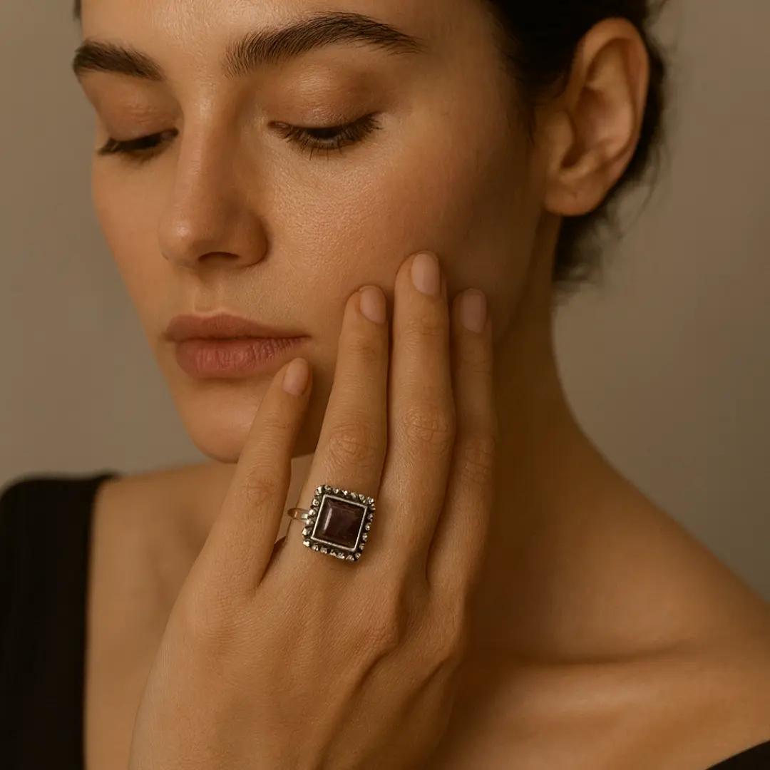 Silver-finish ring with a rectangular matte maroon stone in a beaded frame