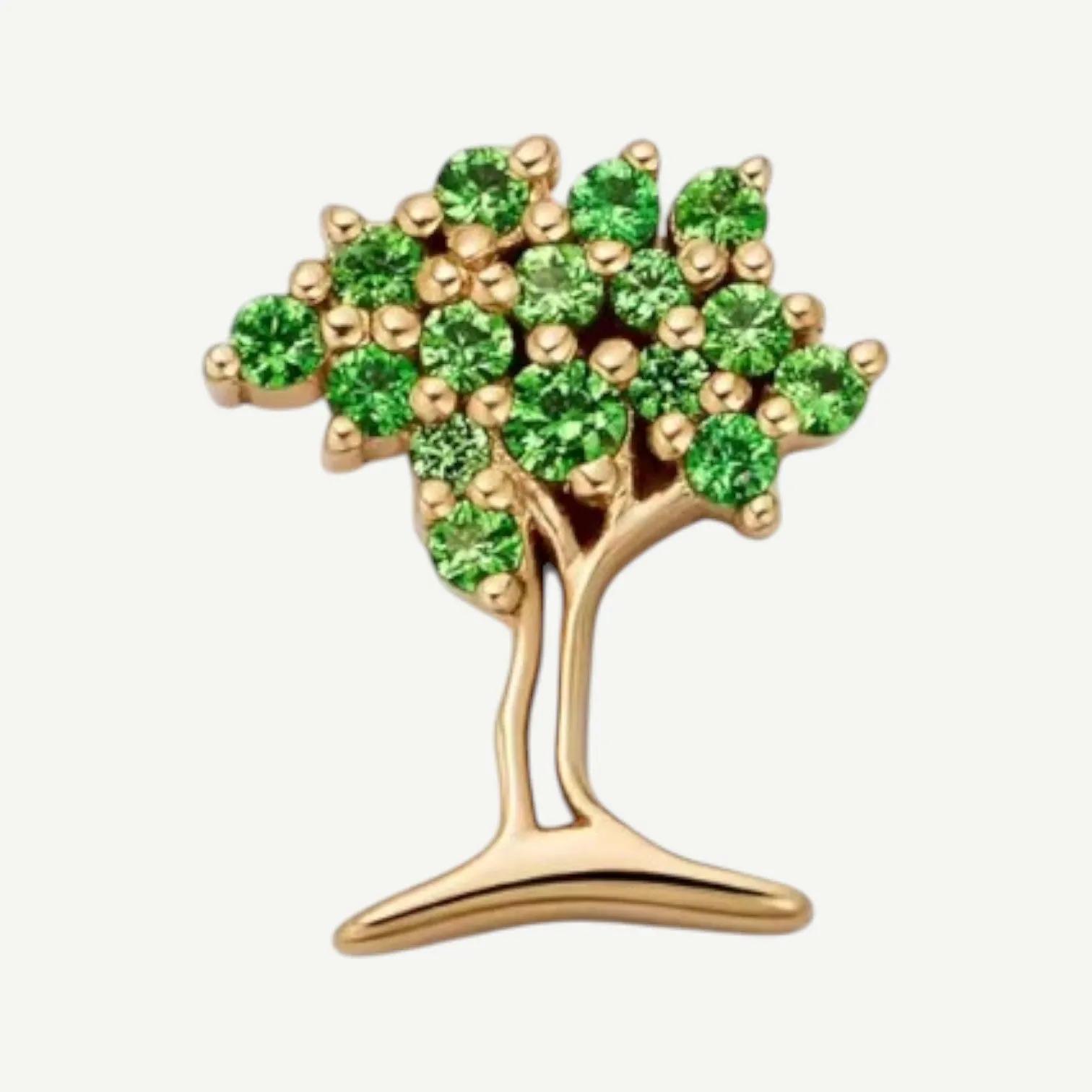Gold-tone tree charm with a canopy of small round green stones and a smooth curved trunk