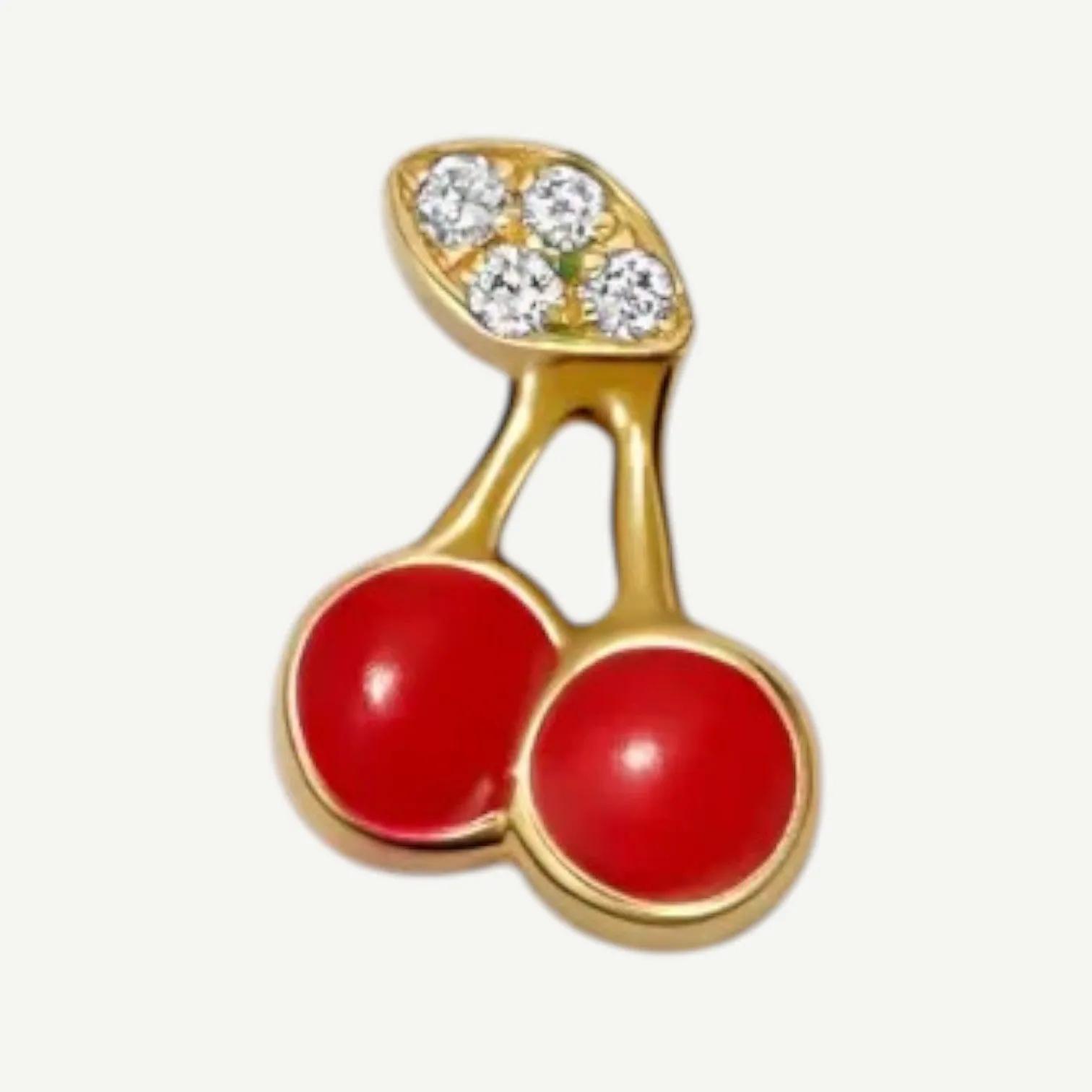 Charm of two glossy red cherries on gold-tone stems with a leaf paved in small clear stones