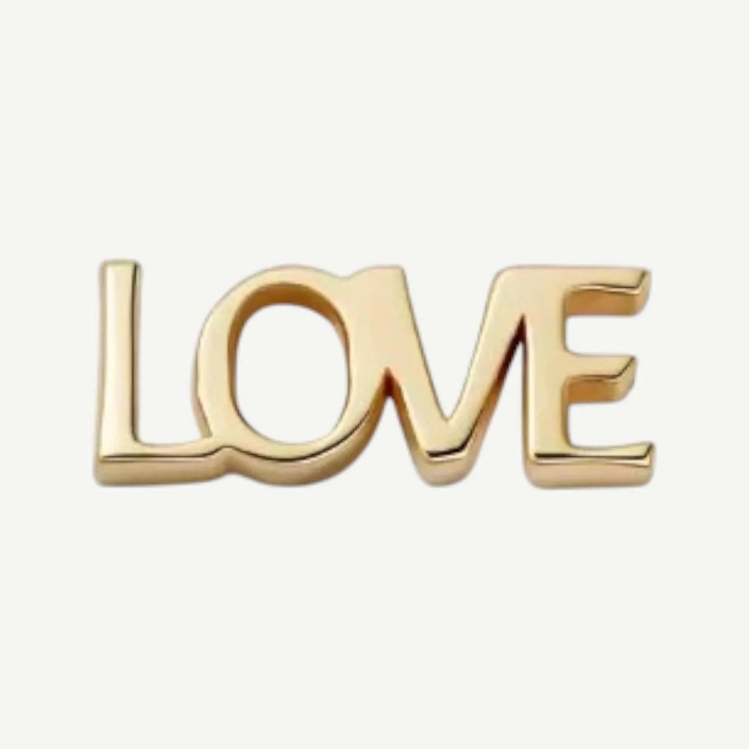 Polished golden charm spelling LOVE in joined block letters without stones