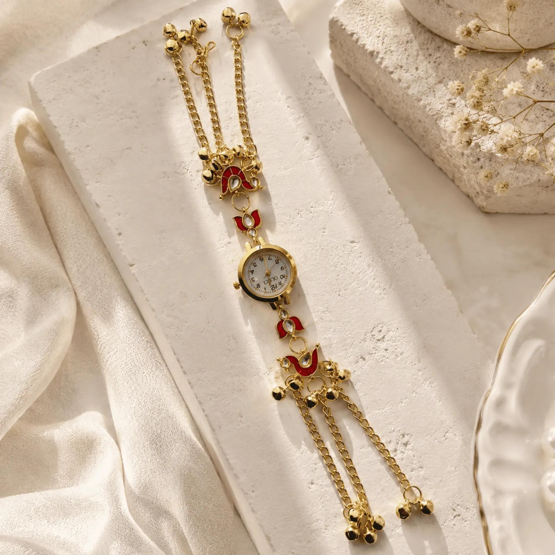 Gold-tone bracelet watch with red meenakari tulip motifs and cascading ghungroo bell chains
