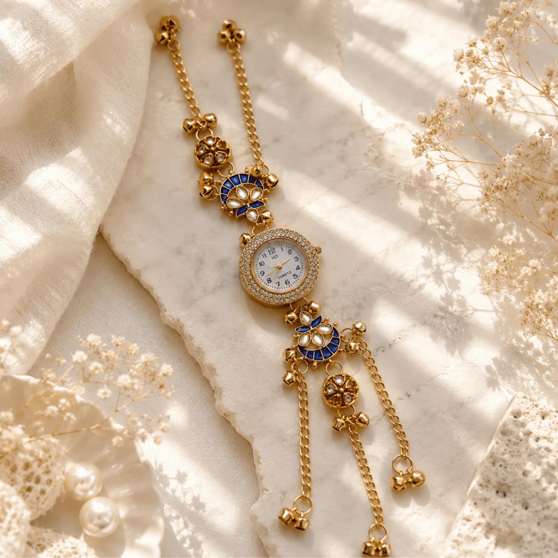 Gold-tone bracelet watch with royal blue meenakari charms and a cubic zirconia edged dial