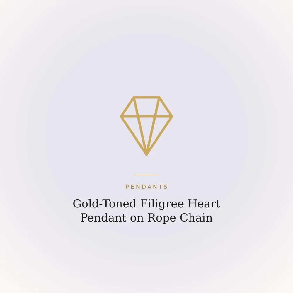 Gold-toned filigree heart pendant on a chunky rope chain necklace