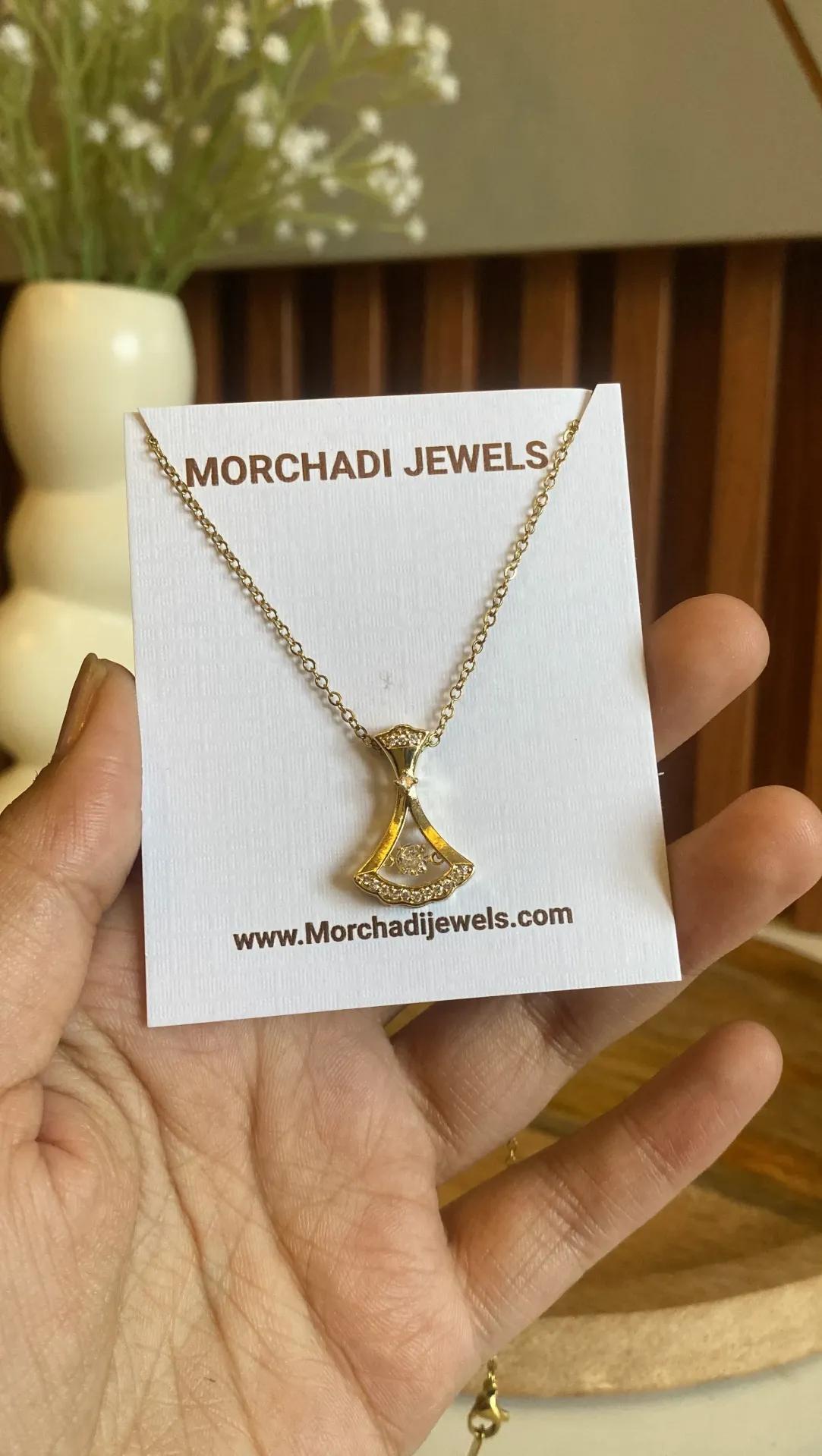 Gold-toned necklace with a fan-shaped pendant set with small clear stones