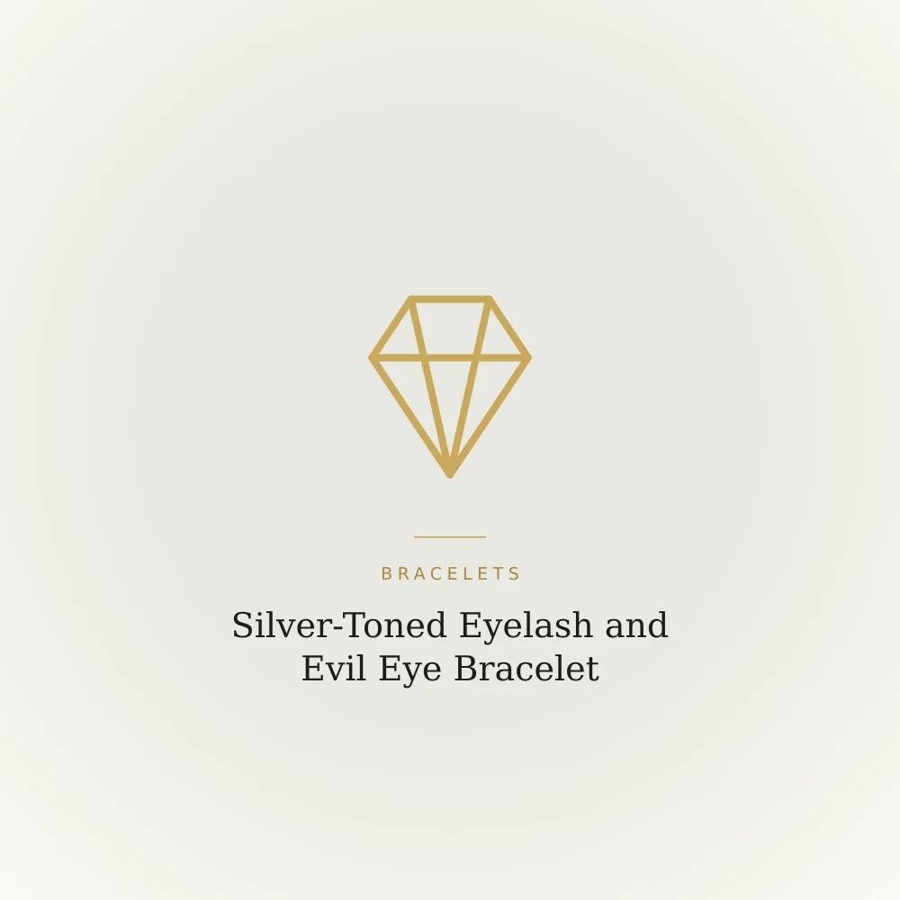 Silver-toned bracelet with an eyelash-shaped charm and an evil eye charm