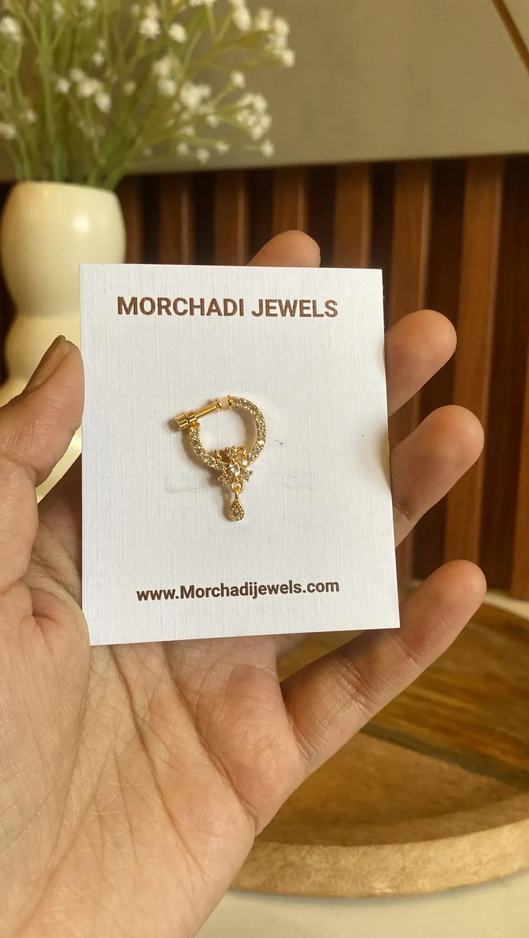 Gold-toned nath with a floral cluster of clear marquise and round stones and a teardrop charm