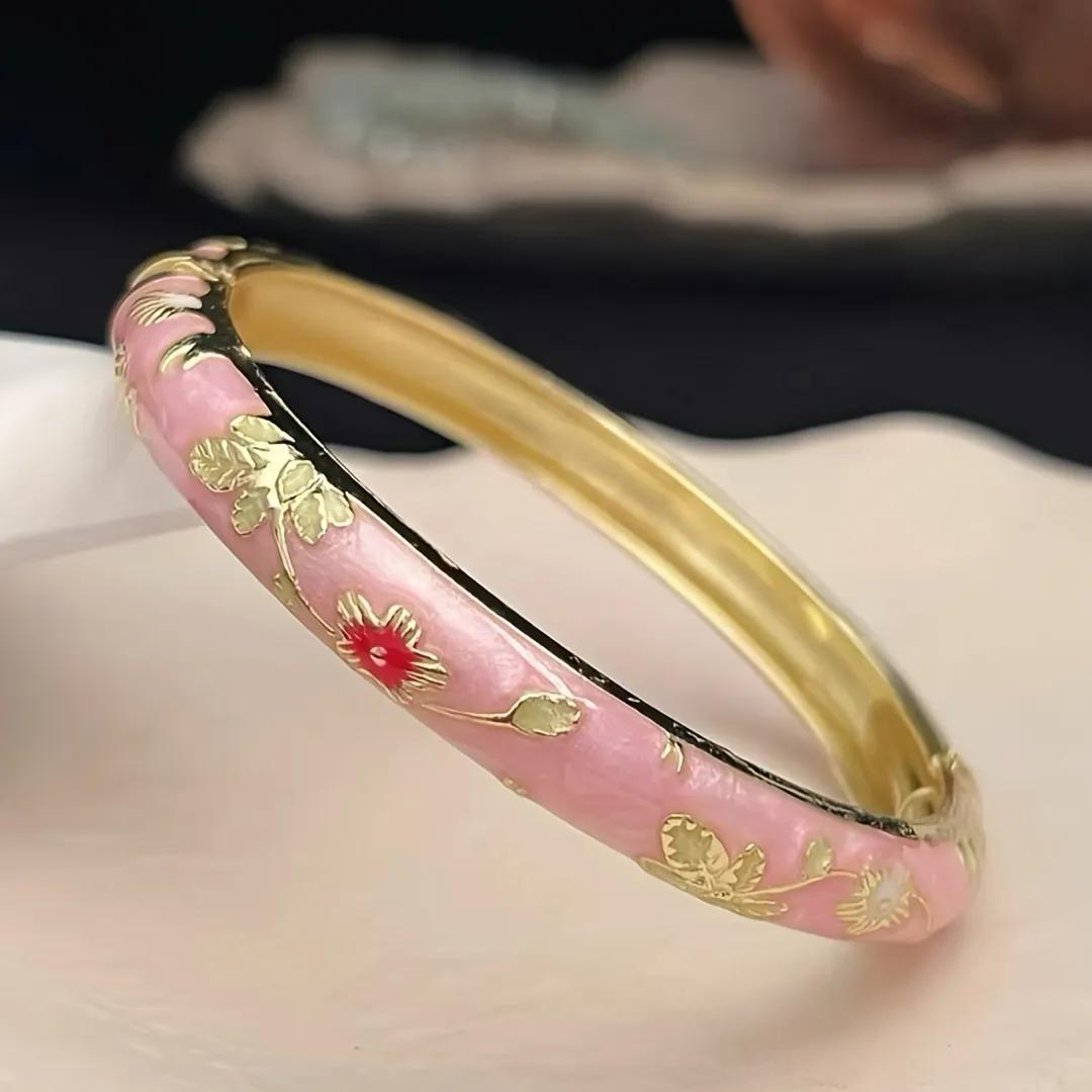 Pearlescent pink enamel kada with red-centred flowers and gold-toned leaf engraving