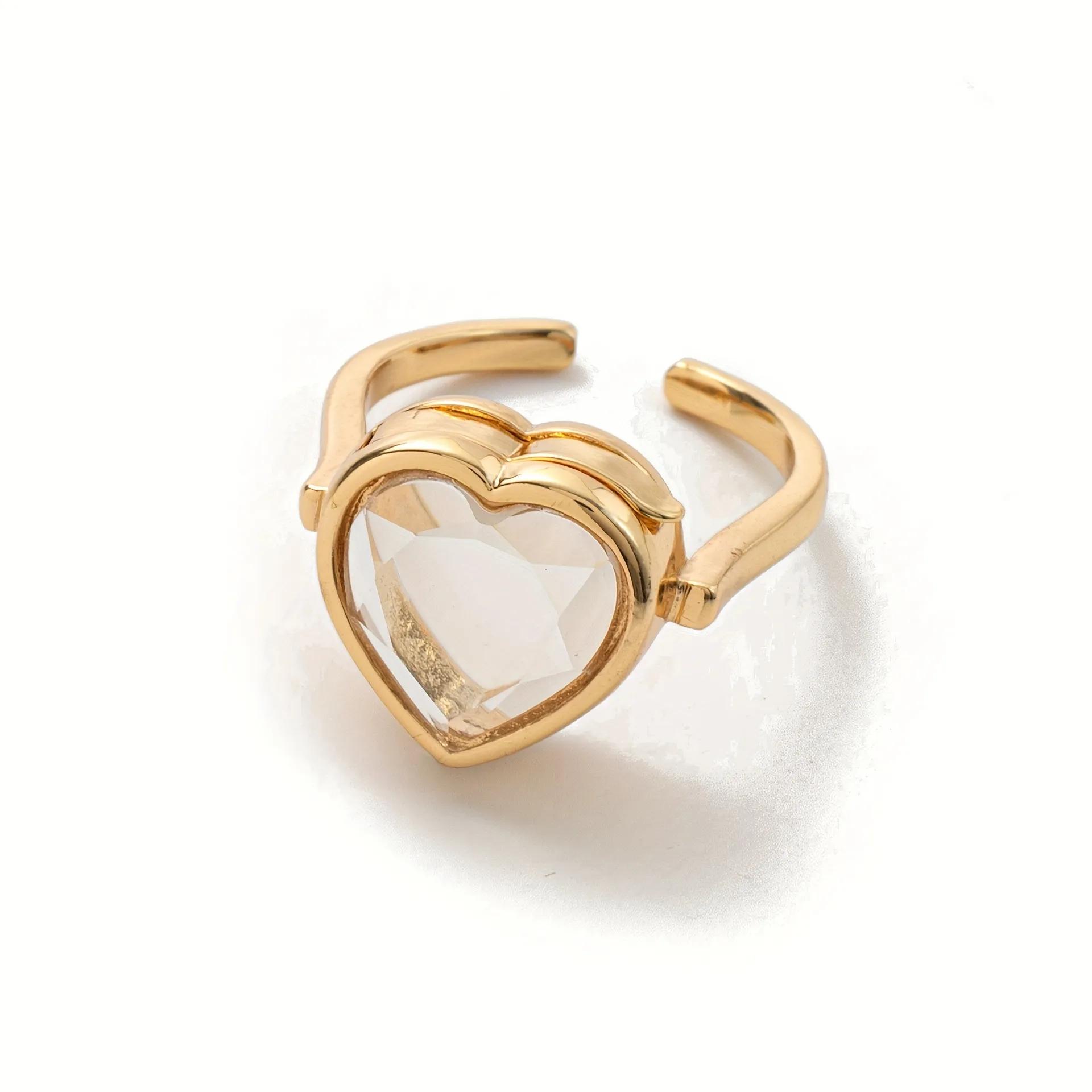 Gold-finished open ring with a faceted heart-shaped locket front, adjustable band