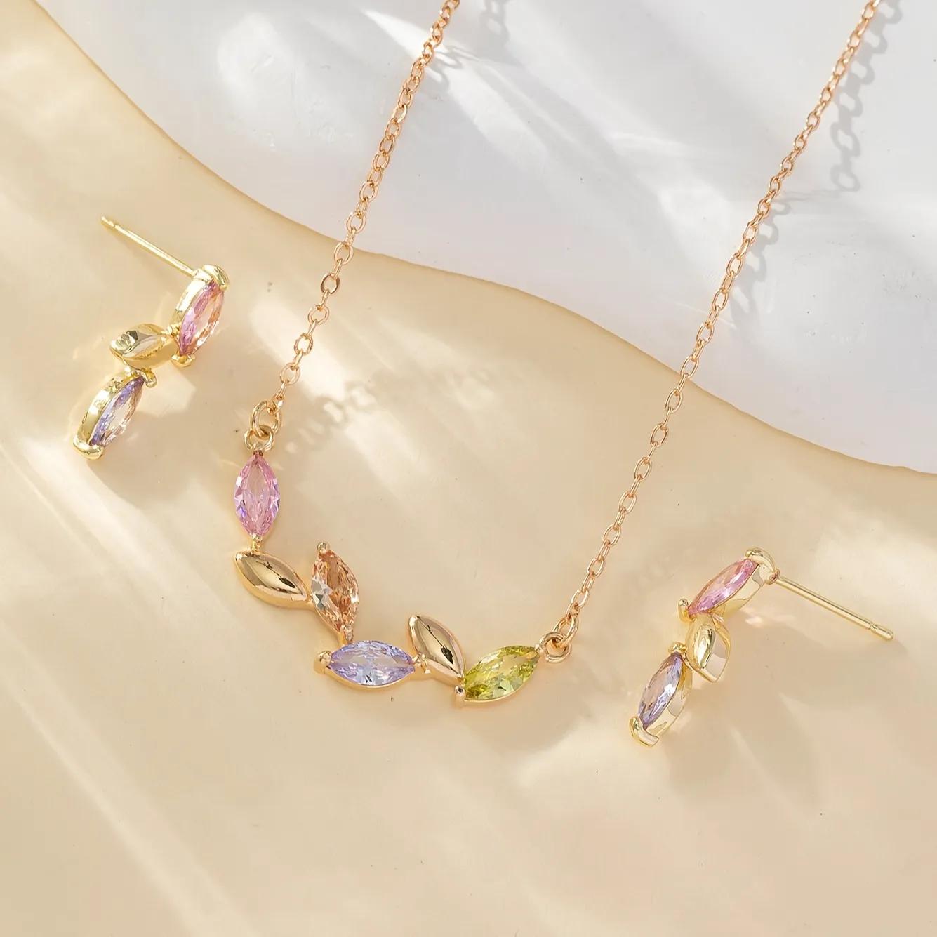 Gold-toned necklace and stud earrings with pink, champagne, lavender and green leaf-shaped stones