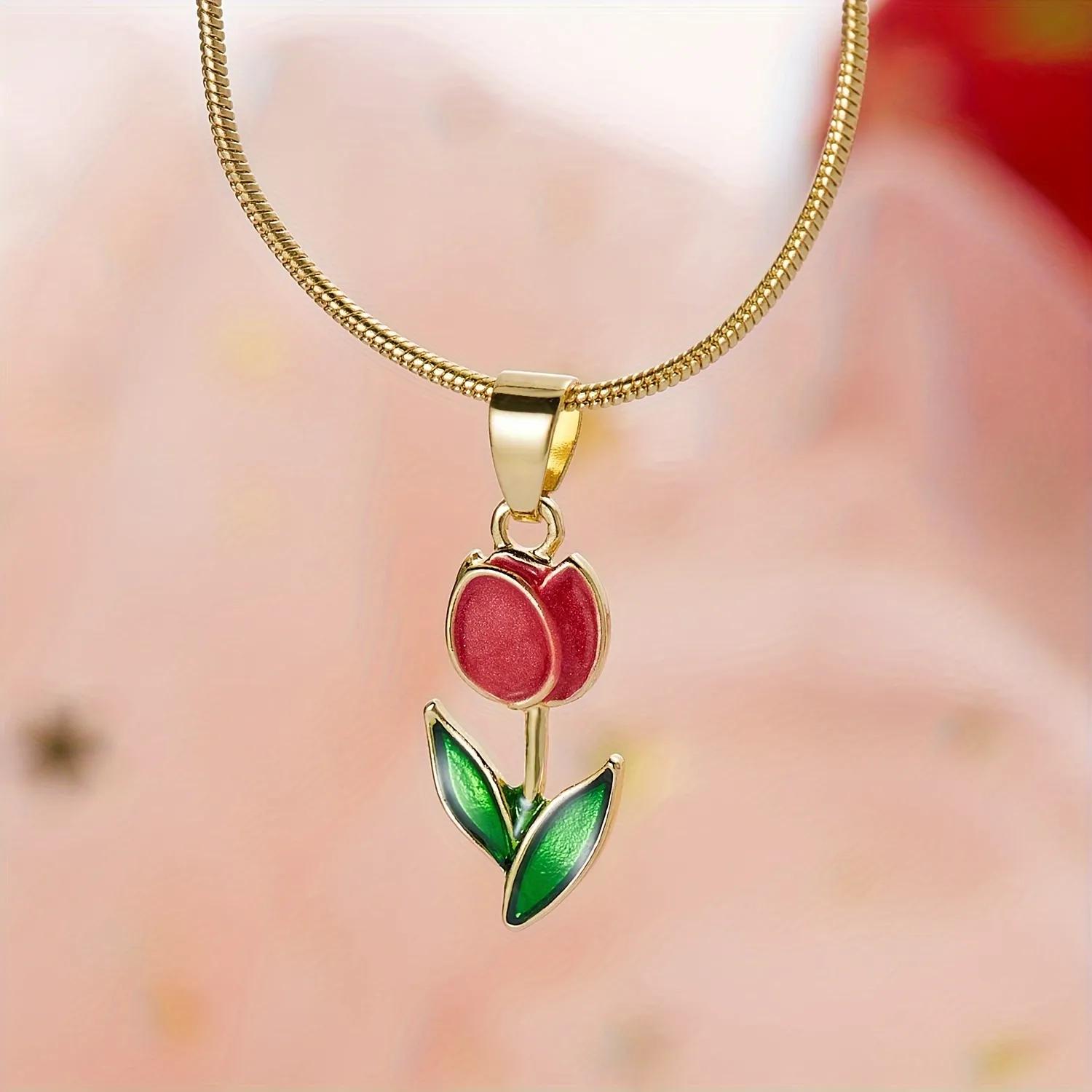 Gold-toned anti-tarnish necklace with a deep red enamel tulip pendant and two leaves