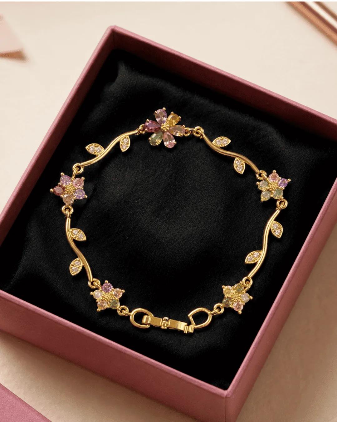 Anti-tarnish gold vine bracelet with four pastel flower clusters in pink, purple, yellow and green