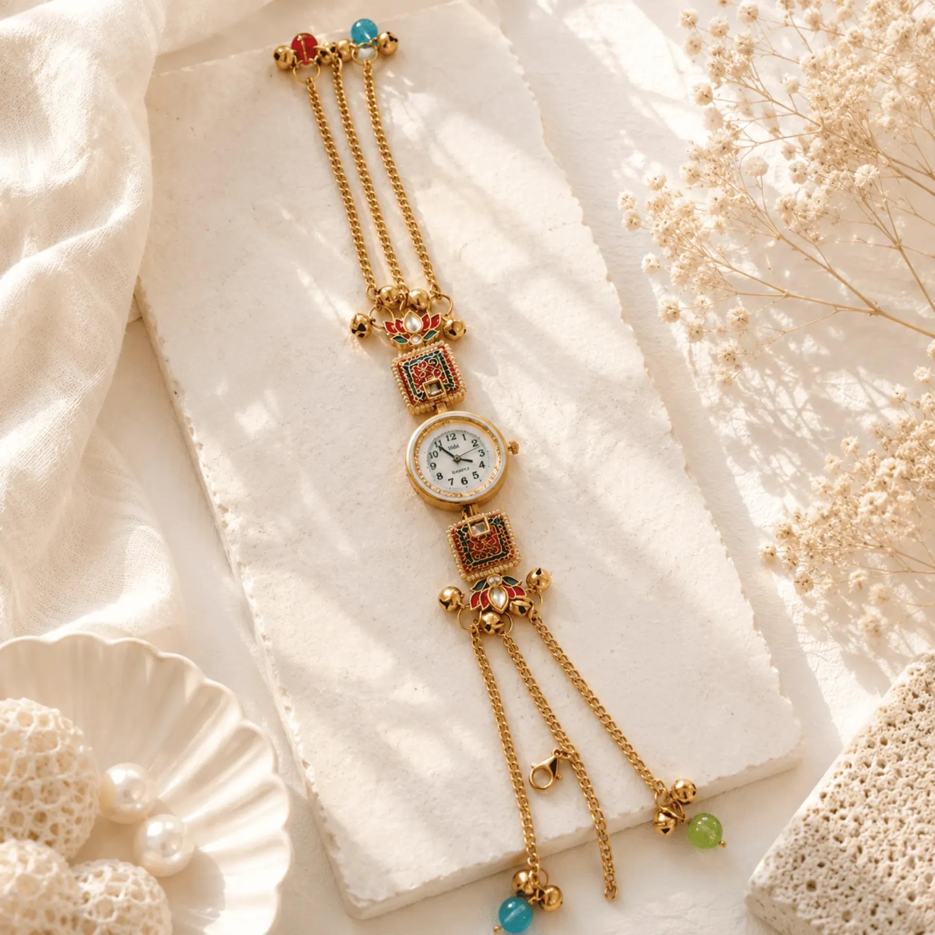 Multi-strand gold chain bracelet watch with meenakari enamel panels, coloured beads and pearl-look accents
