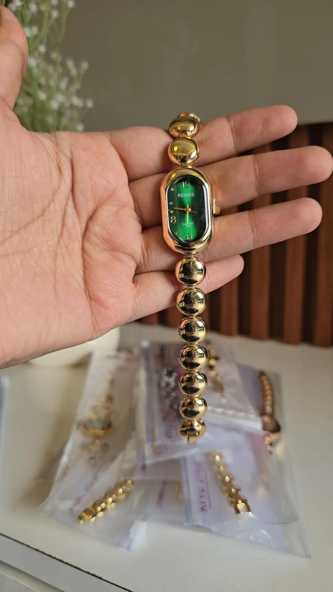 Gold-tone bead bracelet watch with an emerald green rectangular-oval dial and numeral markers