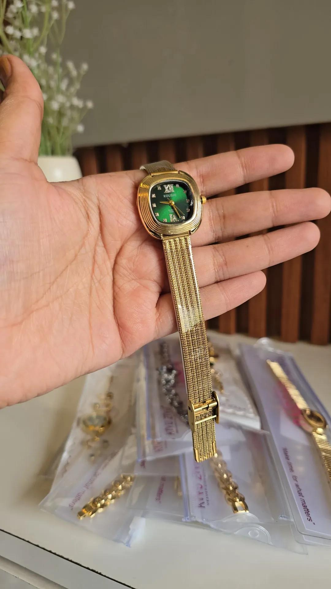 Gold-tone mesh bracelet watch with a solid green square dial