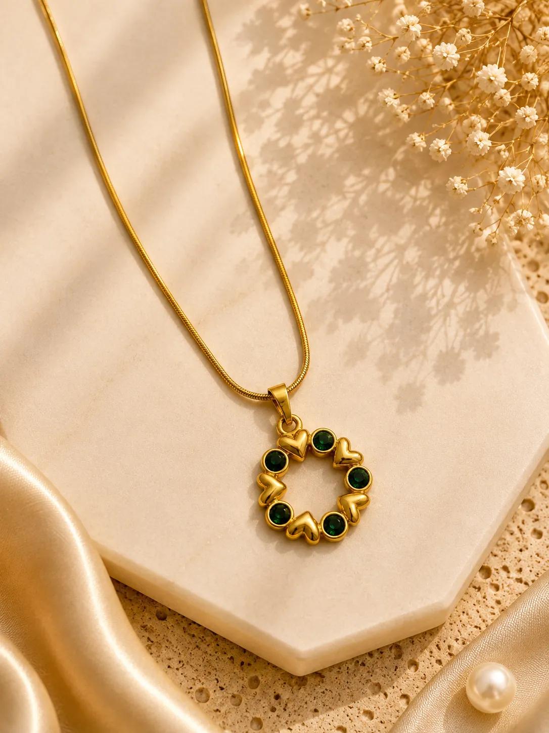 Gold-tone heart wreath pendant necklace set with emerald-green cubic zirconia stones
