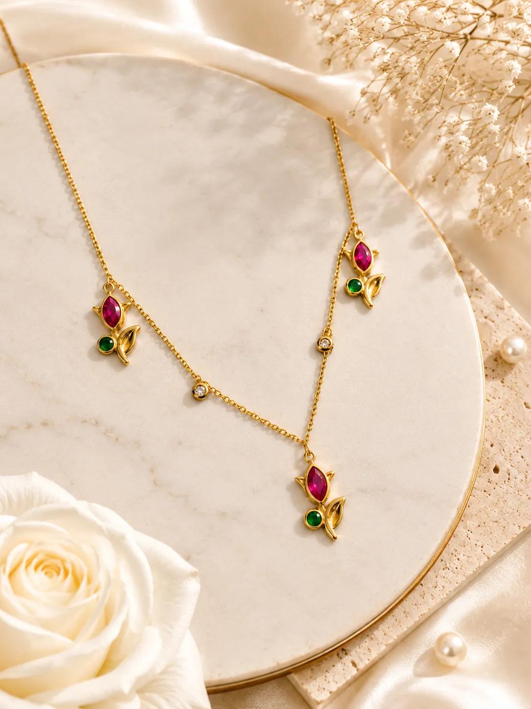 Gold-tone layered necklace with three tulip charms set with pink and green cubic zirconia