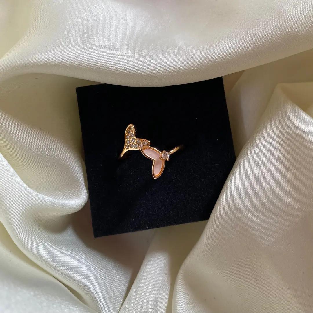 Open bypass ring with one pavé cubic zirconia butterfly wing and one pink shell-look wing in rose gold plating