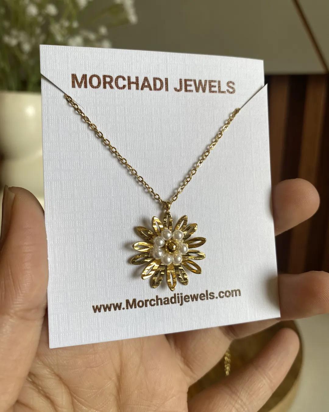 Gold-plated daisy pendant necklace with a cluster of pearl-look beads at the centre