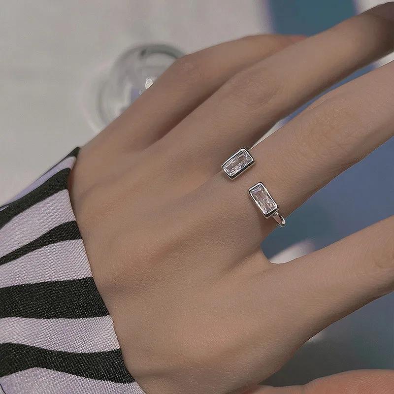 Silver-plated open ring with two staggered rectangular clear stones