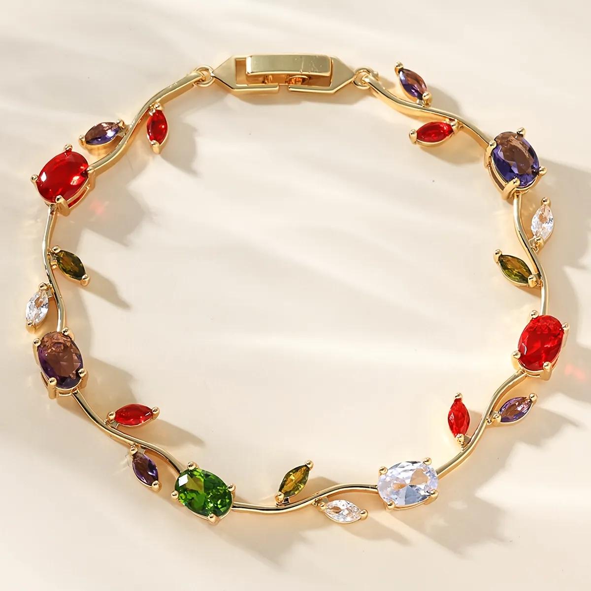 Gold-tone vine bracelet with red, green, violet, amber and clear oval stones arranged in a circle