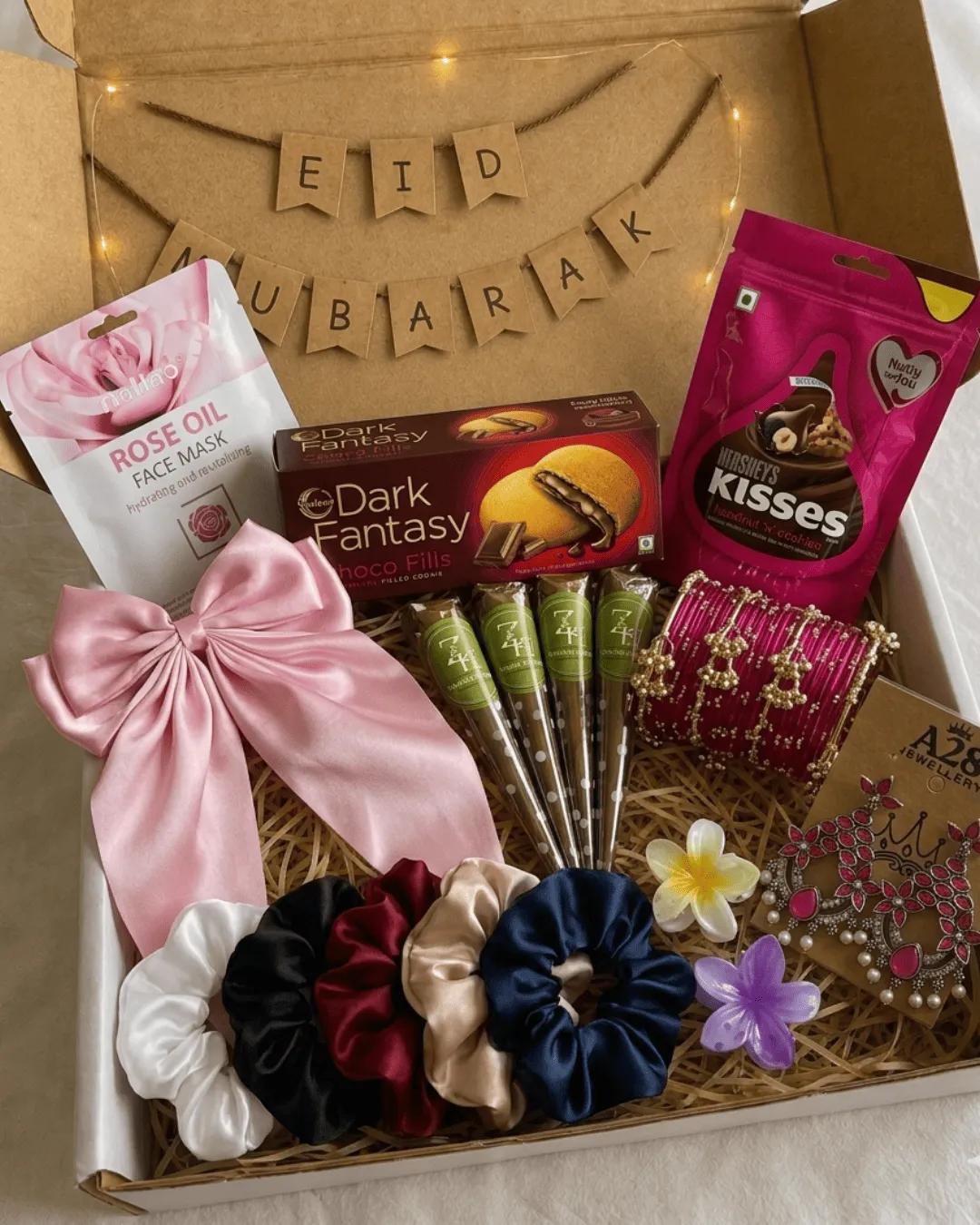 Premium Eid hamper open to show mehndi cones, magenta bangles, earrings and satin scrunchies