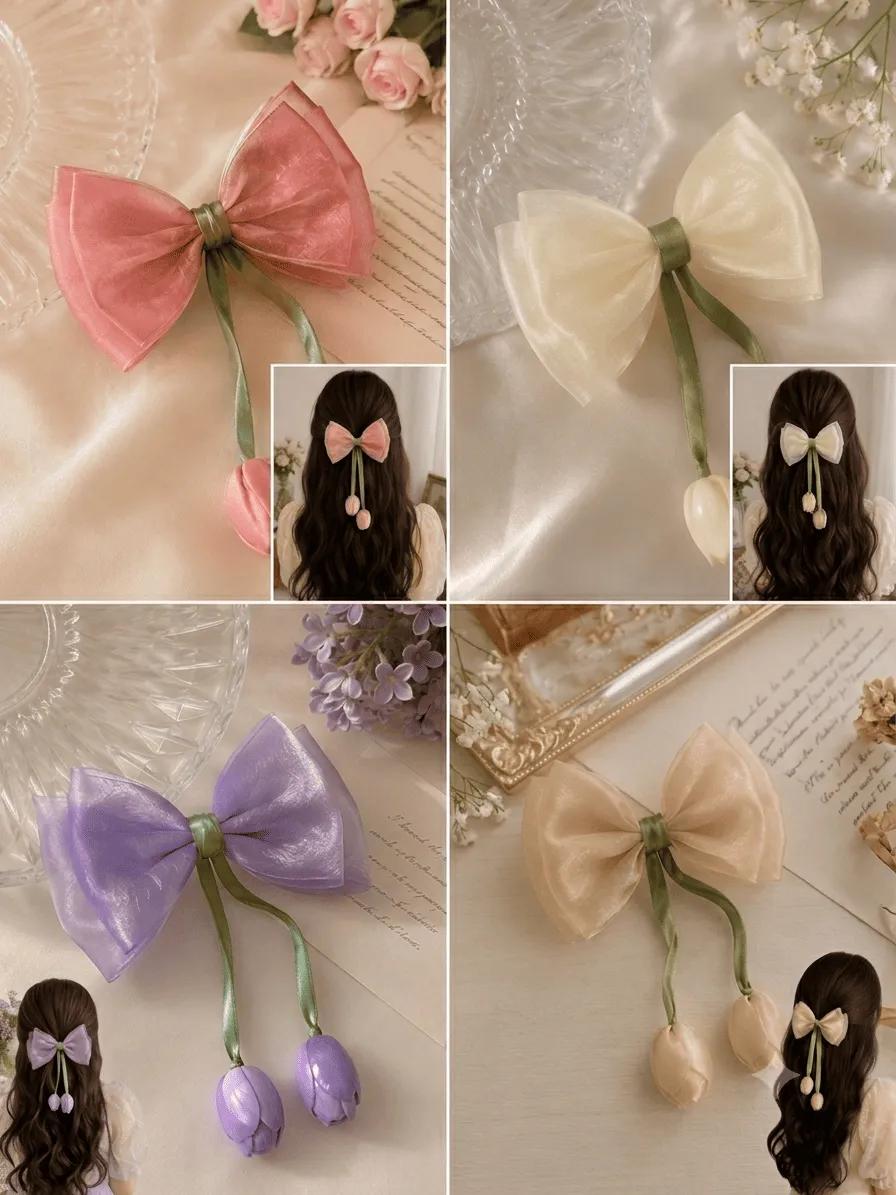 Organza bow hair clip with a hanging satin tulip bud, shown in coral pink, ivory, lilac and champagne