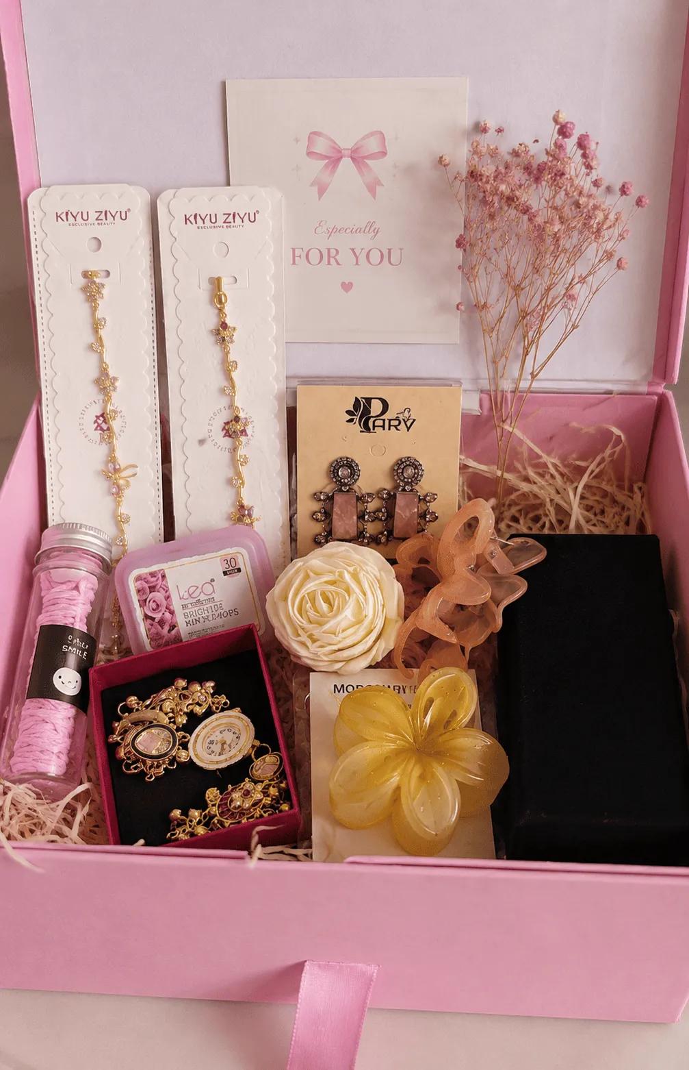 Pink gift box hamper with anti-tarnish bracelets, kundan-style earrings, a watch set and hair clips